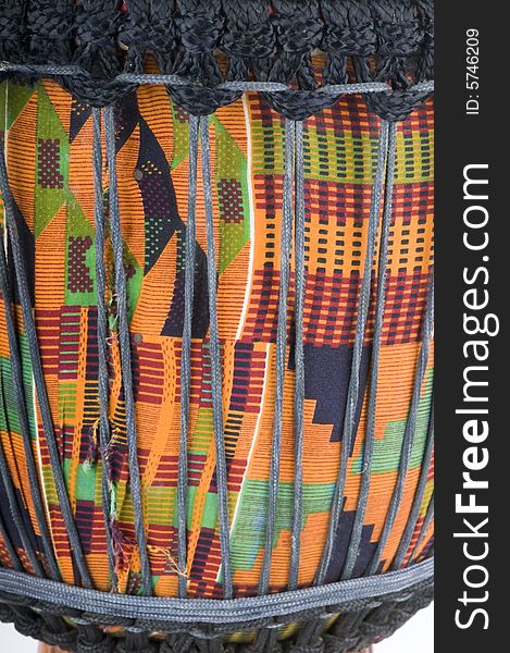 Close up of the draping and chords around a Jemba drum with the typical bright colors of African tradition. Close up of the draping and chords around a Jemba drum with the typical bright colors of African tradition.