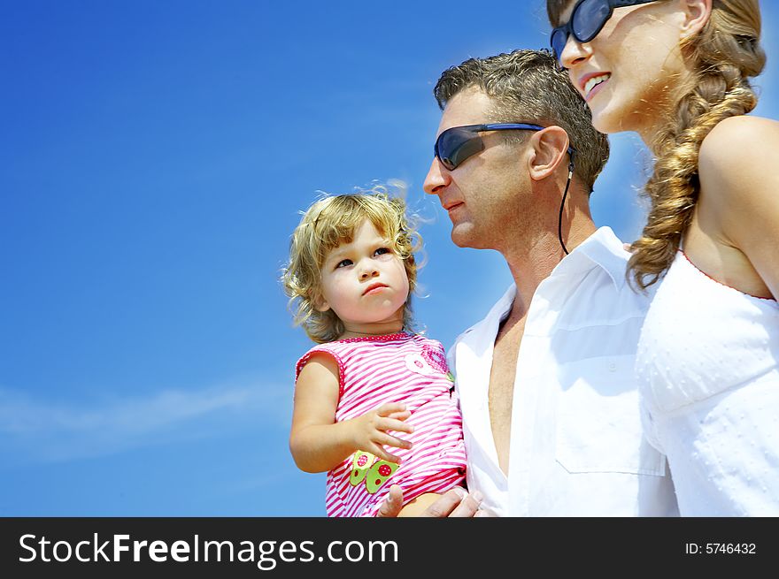 View of young family hanging out in summer environment. View of young family hanging out in summer environment.