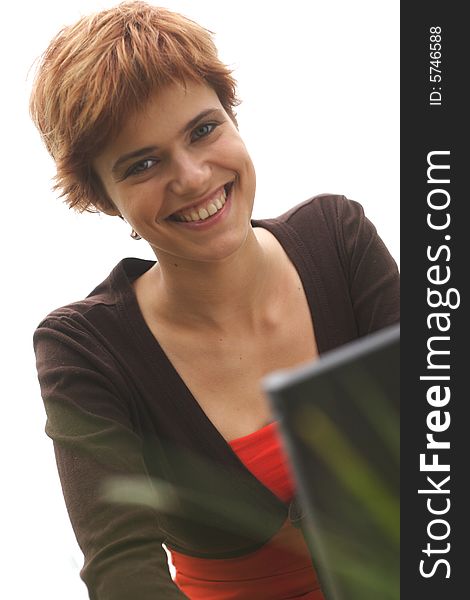 Young woman smiles and working on laptop