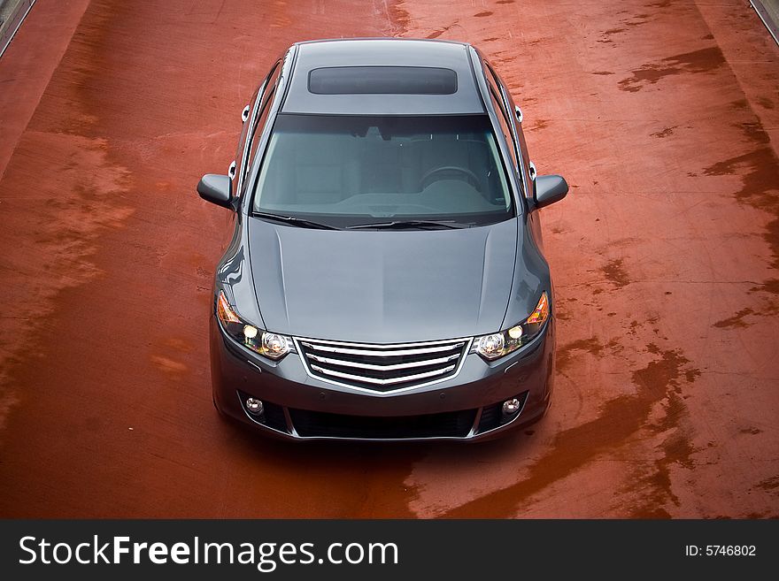 Business sedan front view on a red asphalt. Business sedan front view on a red asphalt.