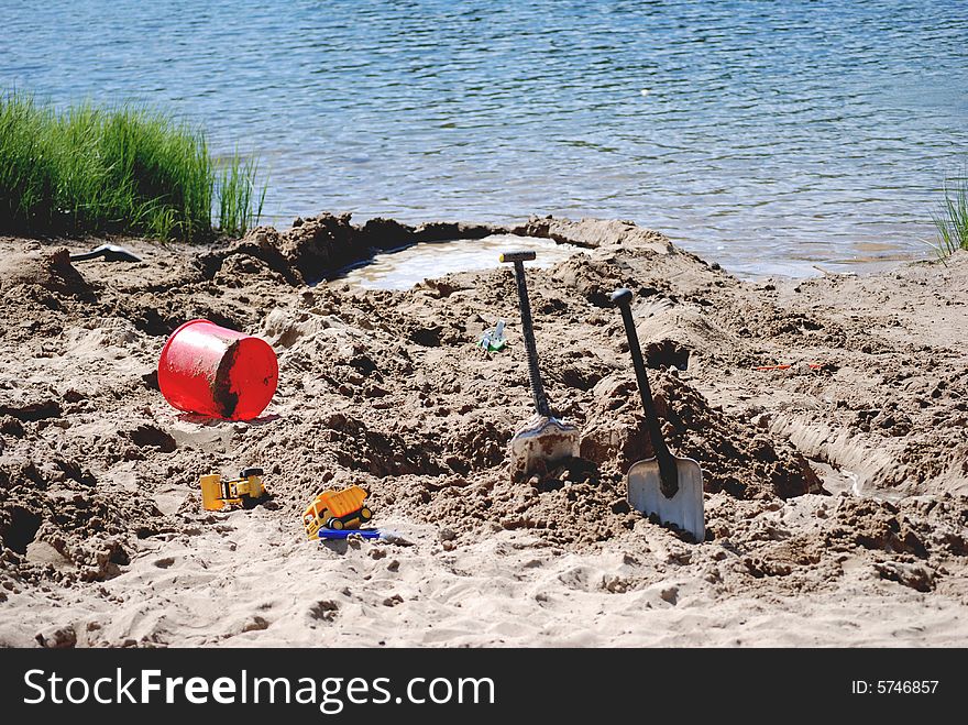 Summer beach and child playing on the sund