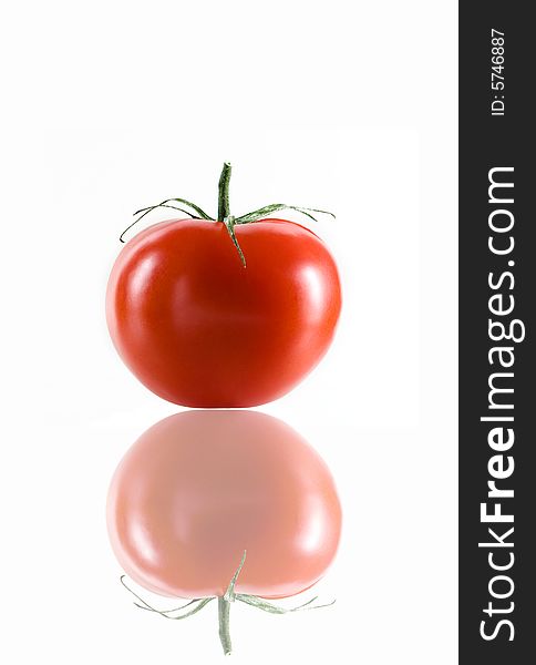 Close up view of nice red fresh tomato on white back