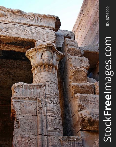 Ornate column and fragment of a wall in the temple of Edfu, Egypt. Existing light, lots of shadows. Ornate column and fragment of a wall in the temple of Edfu, Egypt. Existing light, lots of shadows.