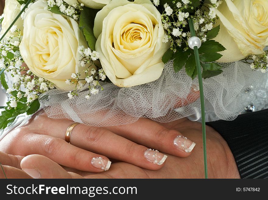 Wedding bouquet of roses holding by bride and groom. Wedding bouquet of roses holding by bride and groom