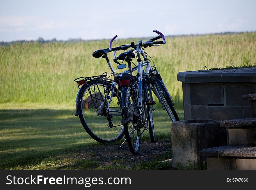 Two bicycles on field background