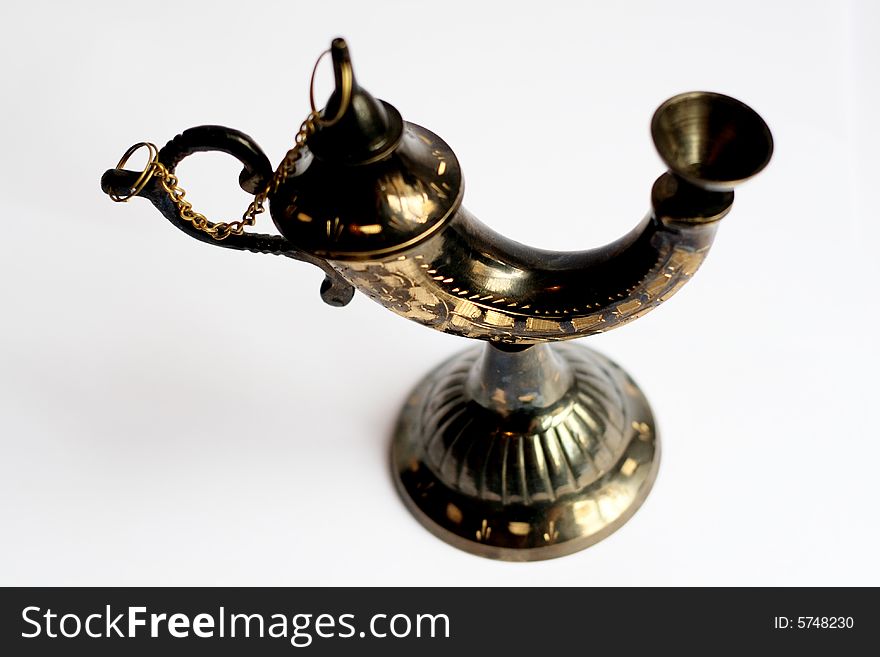 An ornamental Arabic insense holder from Morocco, made of metal and beautifully patterned, on a white background. An ornamental Arabic insense holder from Morocco, made of metal and beautifully patterned, on a white background