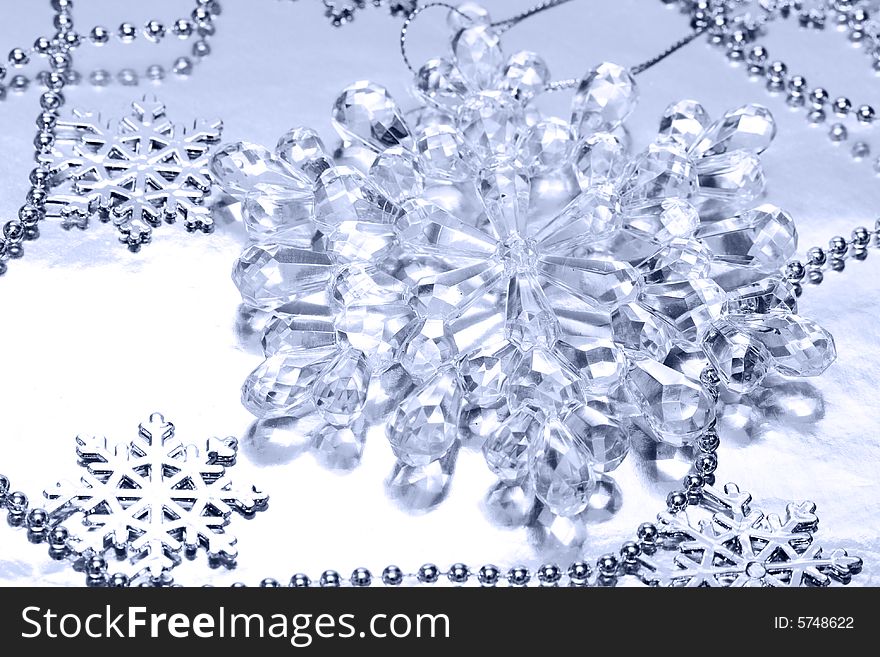 Crystal snowflake on silver background