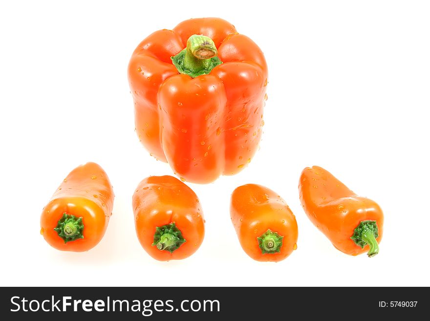 Big and little peppers on white