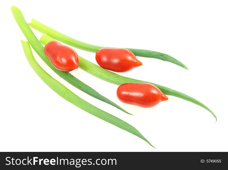 Little tomatoes with spring onion on white