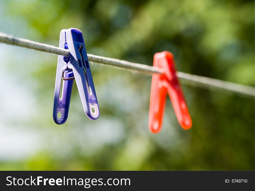 Two linen clothes-pegs hung on rope