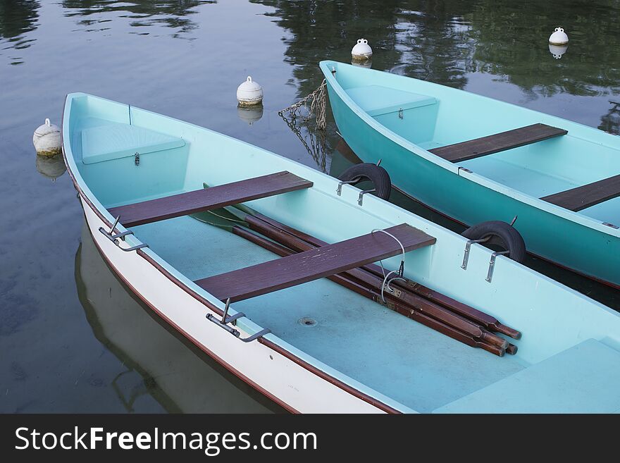 2 Blue Rowing Boats At Border Of Lake