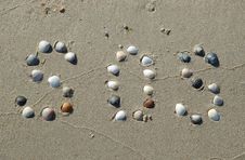 SOS Signal On The Sand Made From Shells Royalty Free Stock Photography SOS Signal On The Sand Made From Shells Royalty Free Stock Photography