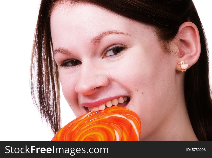 Portrait of a young teen enjoying a giant orange lollypop. Portrait of a young teen enjoying a giant orange lollypop.
