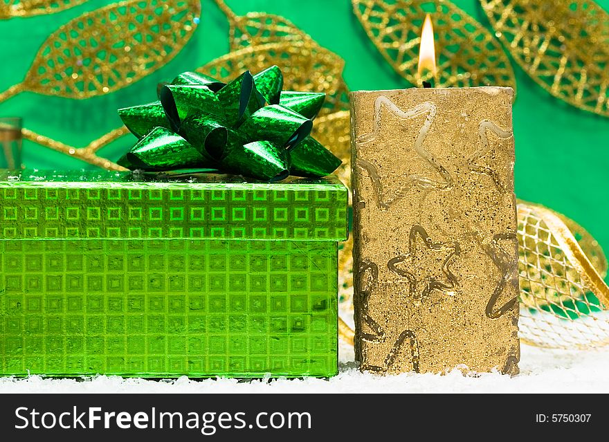Festive candle with green present. Festive candle with green present