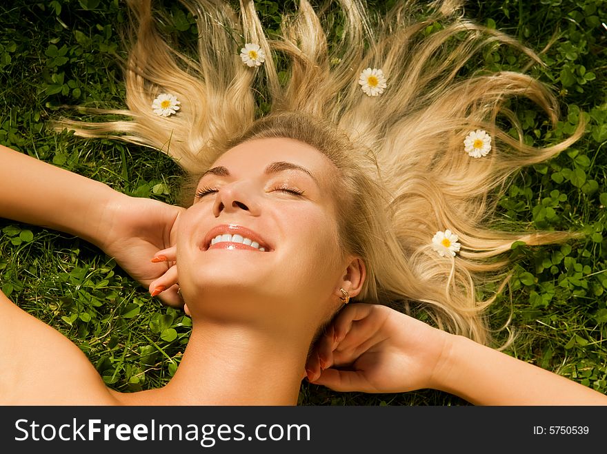 Young woman relaxing on a meadow