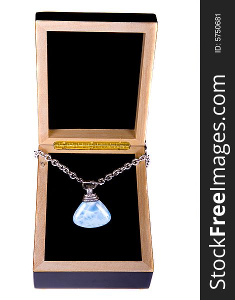 A blue lapis stone on a chain on a display box. A blue lapis stone on a chain on a display box