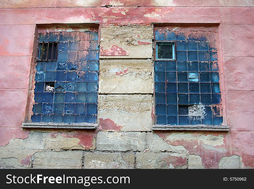 Two windows in an old pink wall. Two windows in an old pink wall