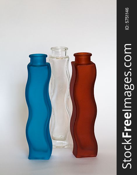 Three glass vases, blue, transparent and red. Three glass vases, blue, transparent and red