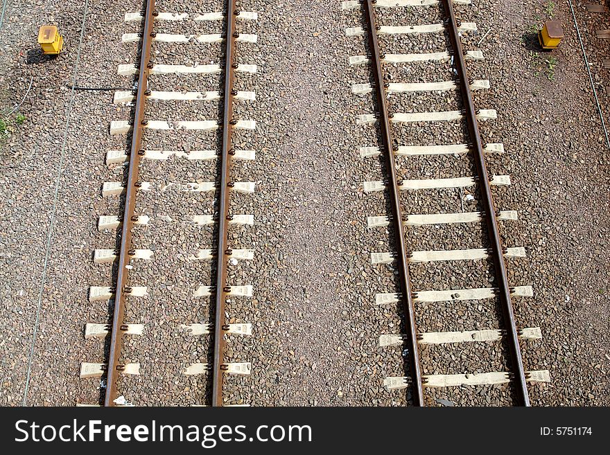 Two railroad tracks with sand in background