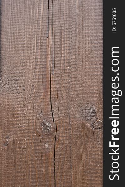 Texture of dark lacquered wood with cracks and knots