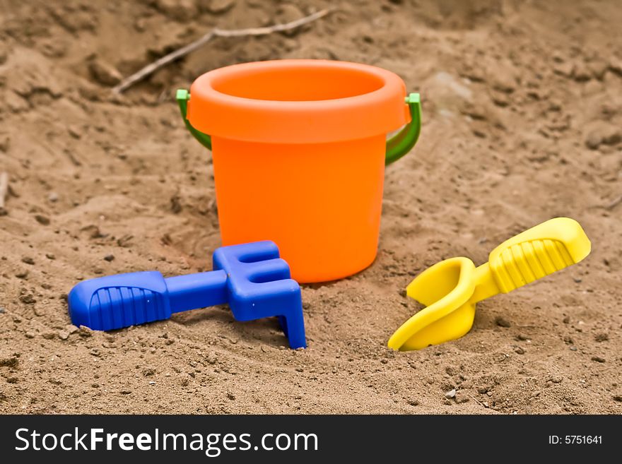Plastic children toys lying in the sand. Plastic children toys lying in the sand