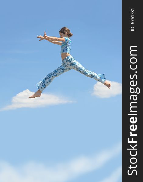 Beauty girl jump on sky clouds for your design