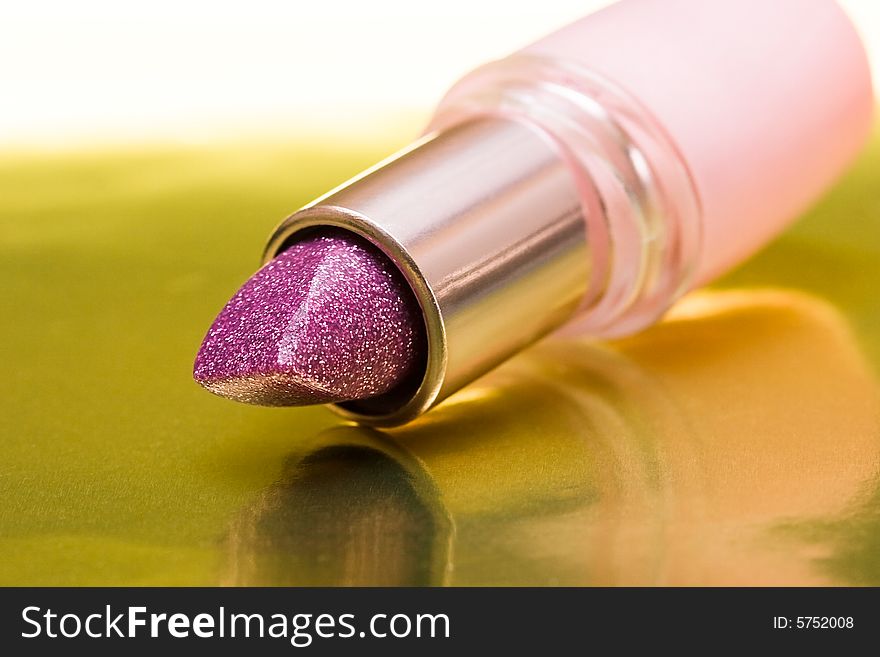 Violet lipstick on yellow background