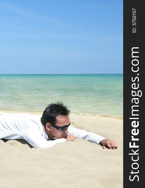 Man lie down on tropical beach sand