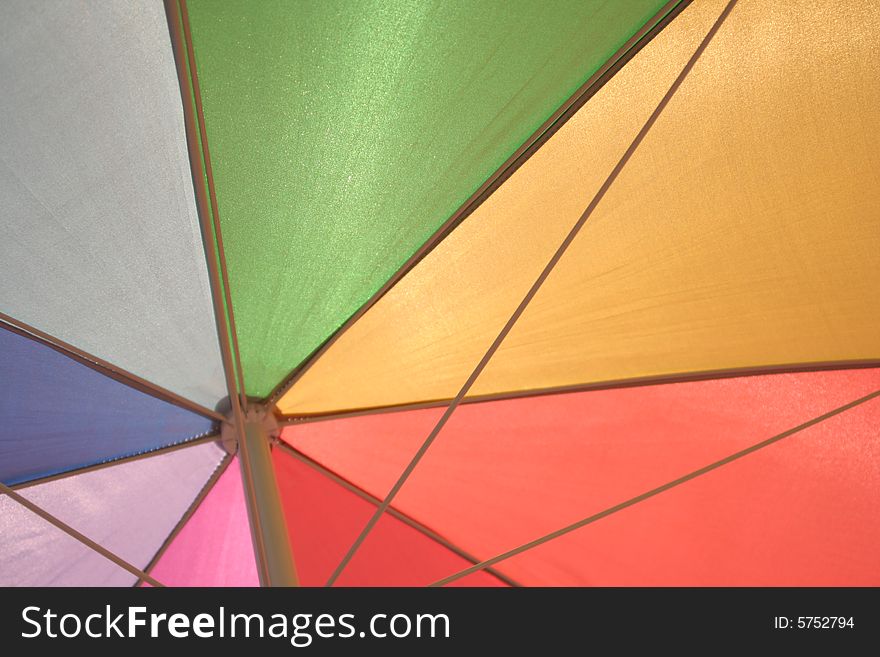 Under a brightly colored umbrella