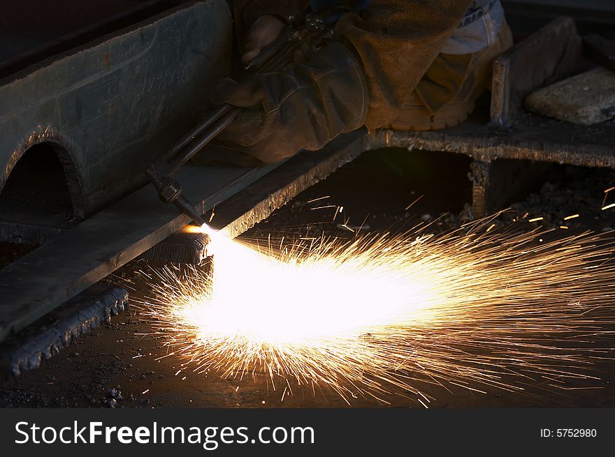 A shipyard steel worker burning steel. A shipyard steel worker burning steel