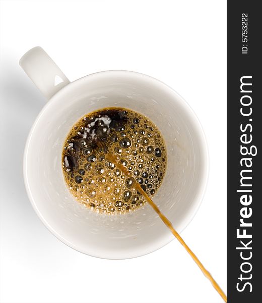 Fresh coffee being poured into a coffee cup on a white background.