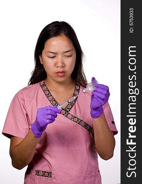 Medication Nurse drawing out a medication from the syringe.