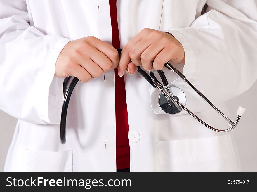 Health care worker in a scrubsuit holding a stethoscope.