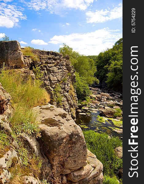 A gorgeous canyon with river, rocks and clouds