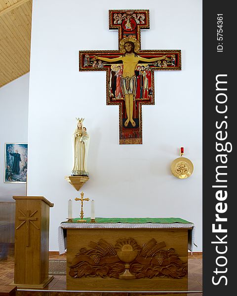 Altar in a little church with a cross on a wall. Altar in a little church with a cross on a wall