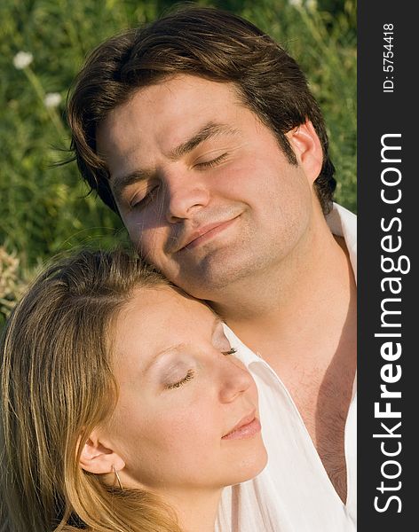 Portrait of happy couple with closed eyes