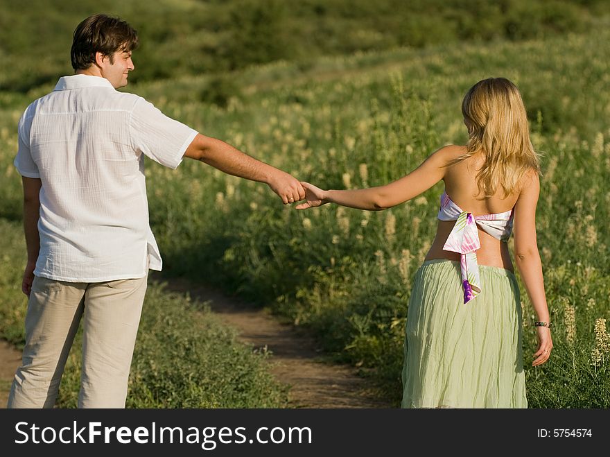 Young married couple on the walk, woman is pregnant