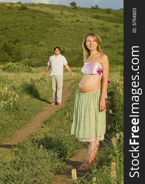 Young married couple on the walk, woman is pregnant. Young married couple on the walk, woman is pregnant