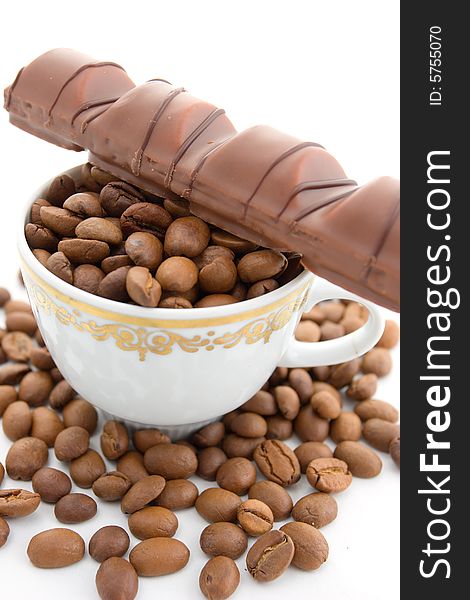 Coffee beans and chocolate in the cup on a white background. Coffee beans and chocolate in the cup on a white background