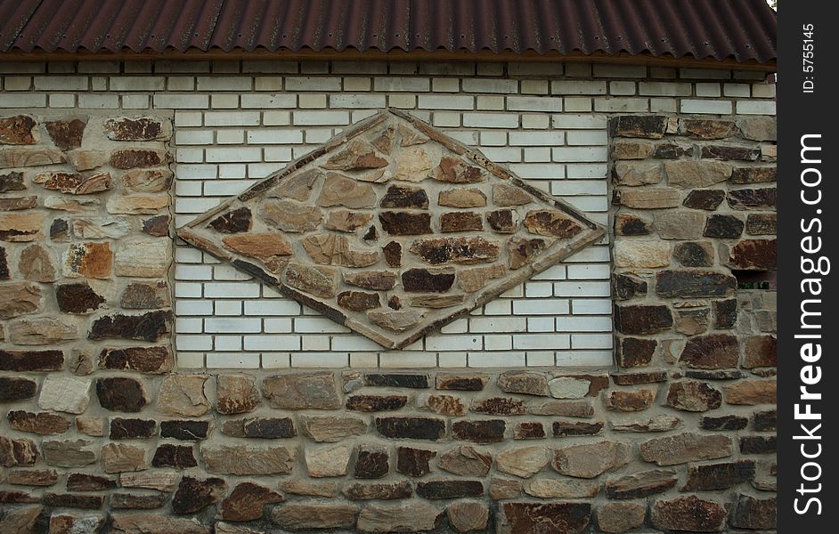 Fence from a stone and bricks, fencing a residence. Fence from a stone and bricks, fencing a residence