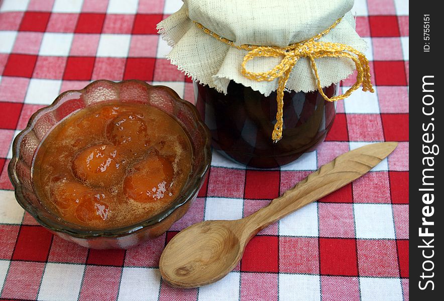 Apricot jam of house preparation on a red checkered cloth