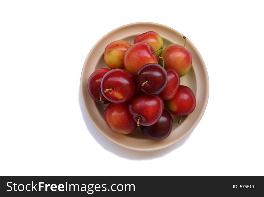 Plums on plate isolated on white bacground