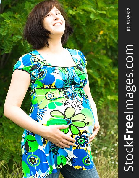 Pregnant woman relaxing on grass. Pregnant woman relaxing on grass
