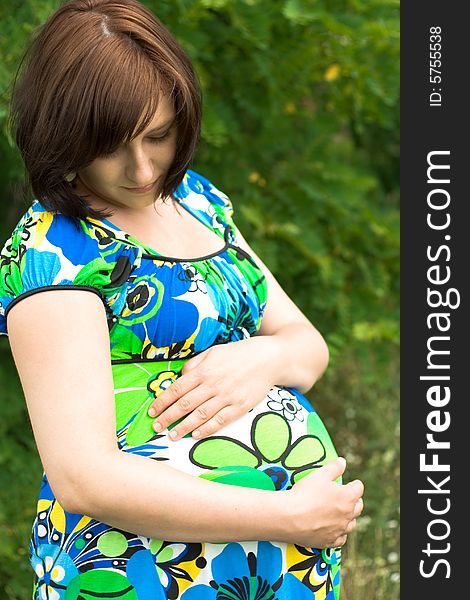 Pregnant woman relaxing on grass. Pregnant woman relaxing on grass