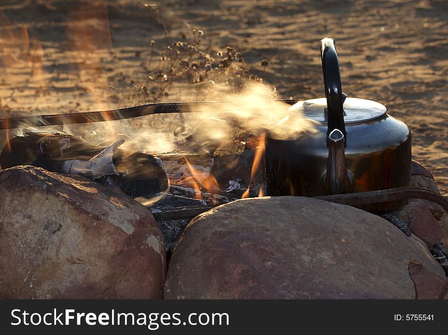 Coffee brewing on an open flame early in the morning