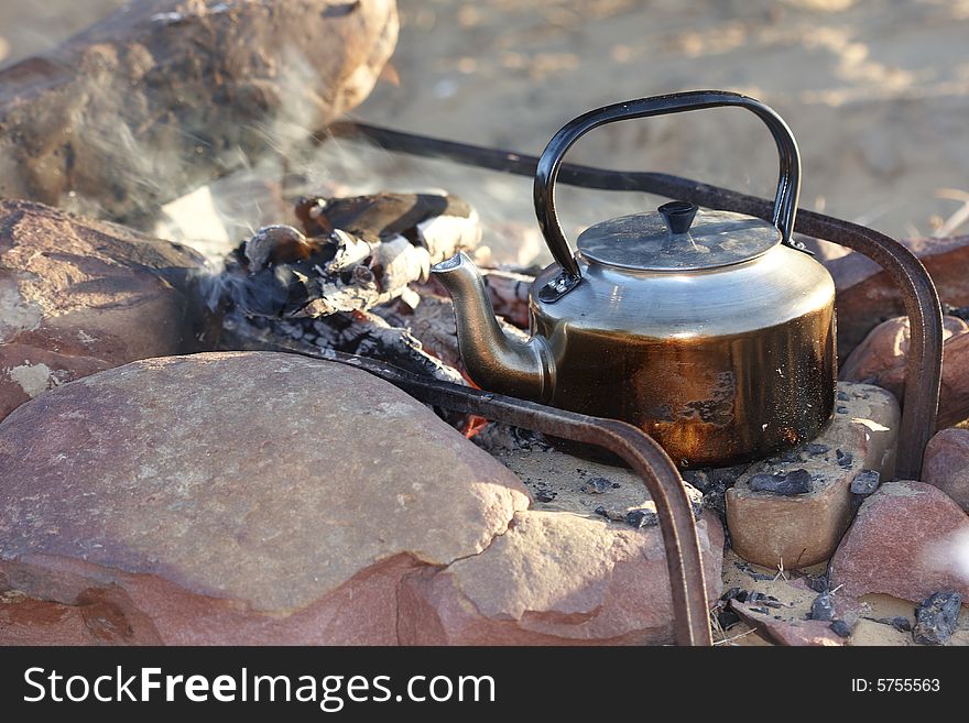 Brewing coffee in the dessert on an open flame. Brewing coffee in the dessert on an open flame