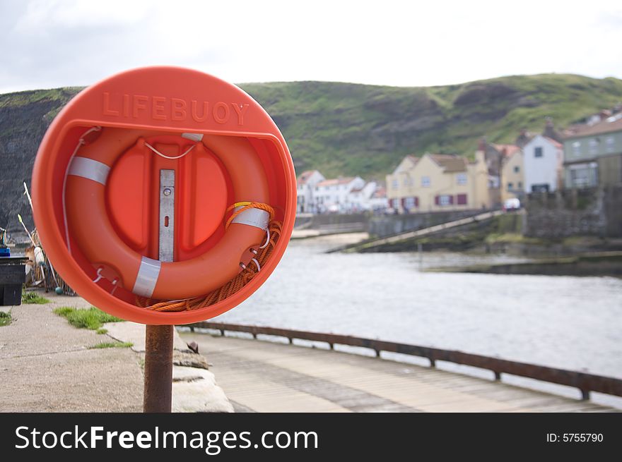 Lifebuoy. Life preserver alongside a harbour