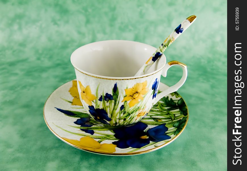 Tea cup whis flover and spoon on background. Tea cup whis flover and spoon on background