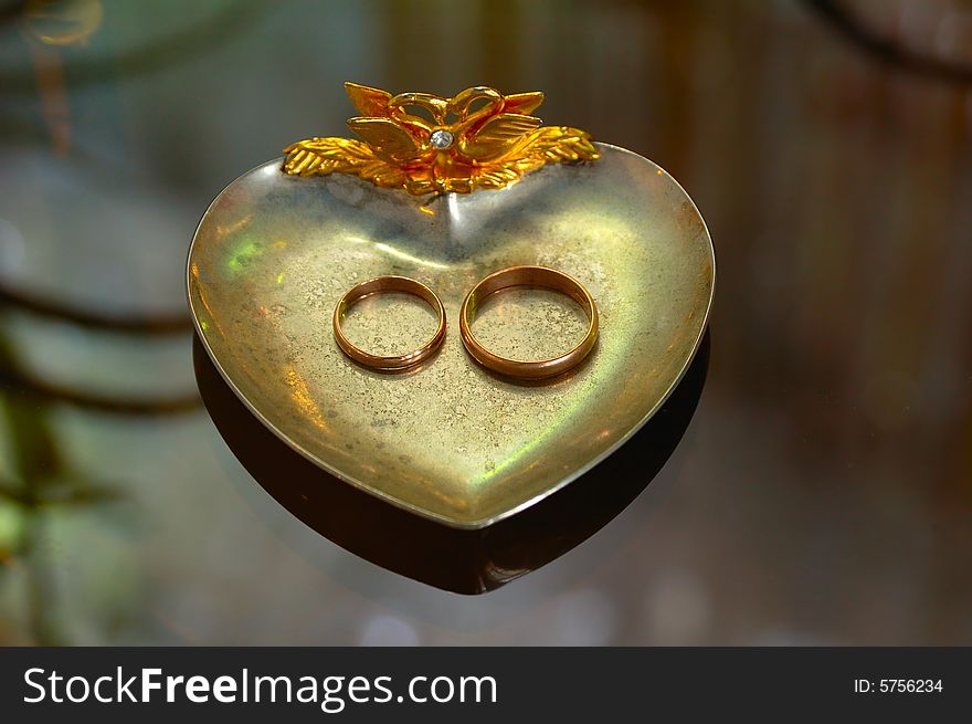 Two wedding rings lying on silver plate. Two wedding rings lying on silver plate