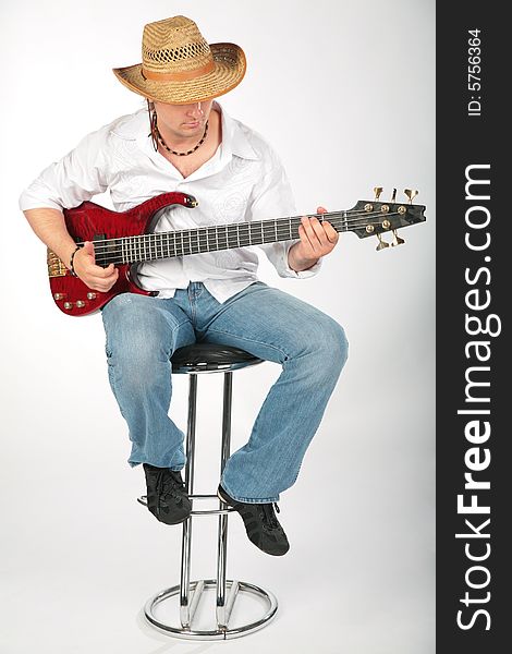 Guitar man with hat on chair